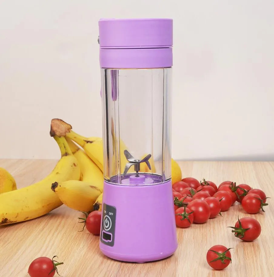 Mini USB-powered centrifugal fruit juicer in pink, with a 400ml plastic cup and stainless steel blade.