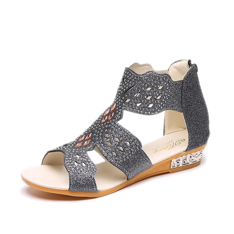 Women's flat open toe sandals with rhinestone details and a back zipper in gold.