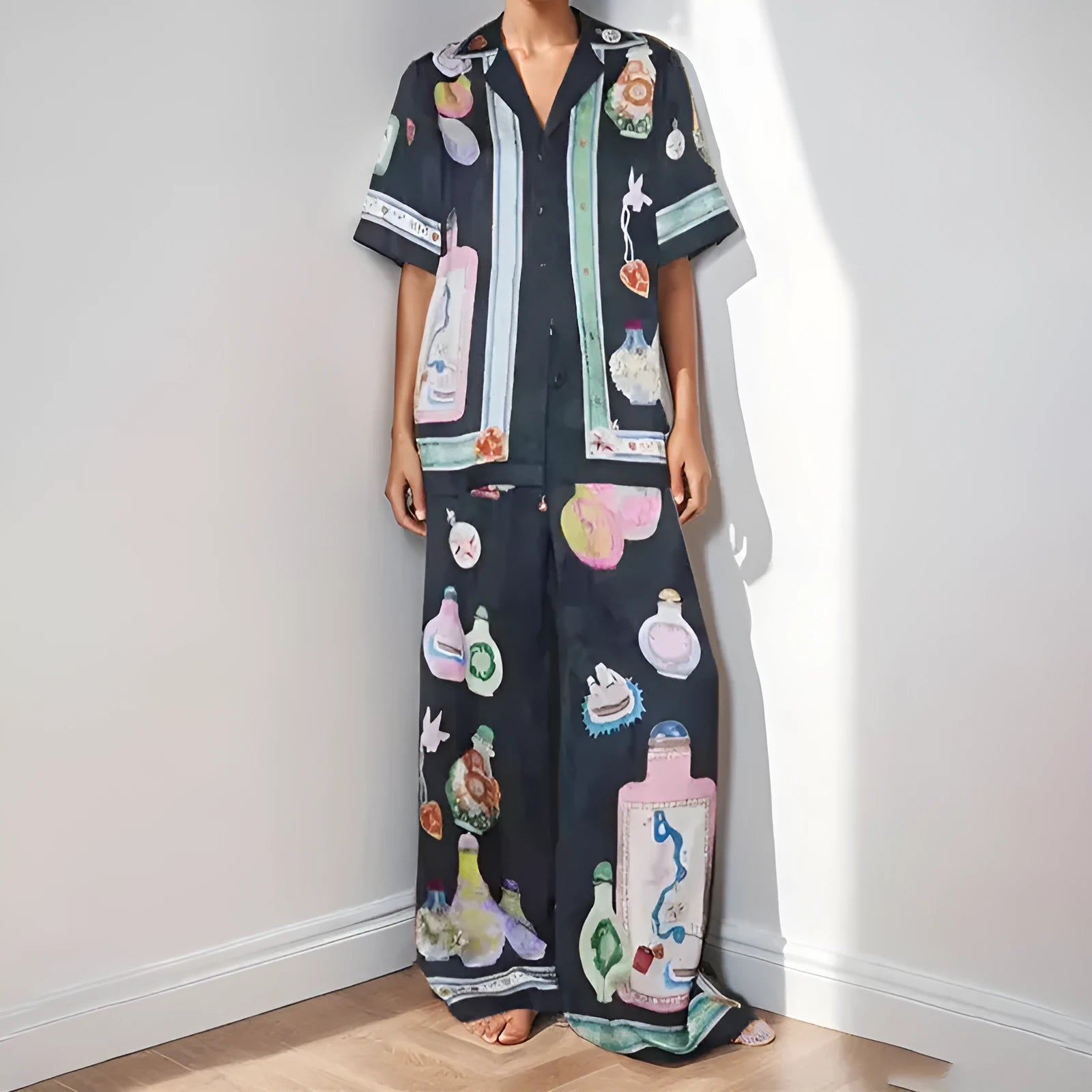 Black women's co-ord set with cartoon animation print, featuring a cardigan and trousers.