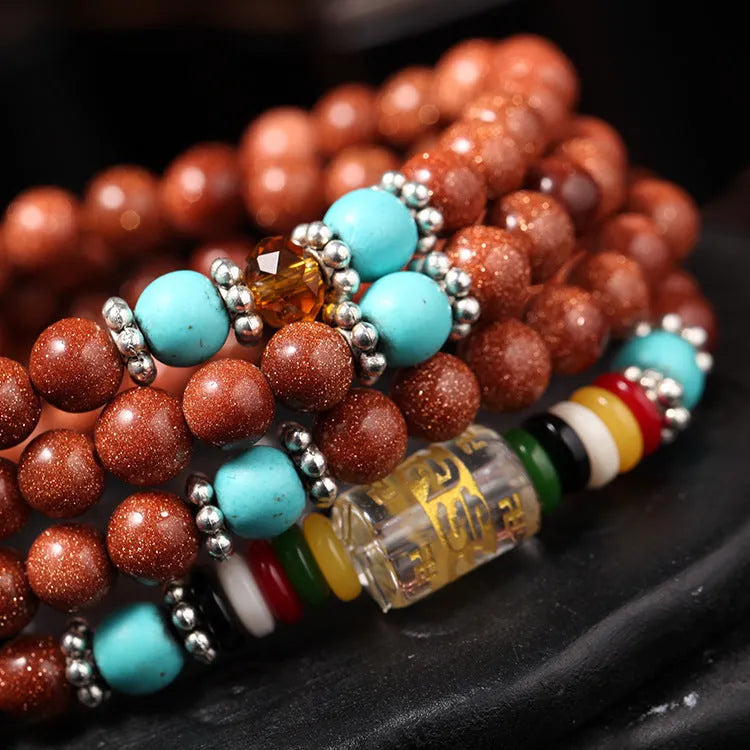 Golden star stone bracelet with 108 nugget sand beads and a fu character charm.