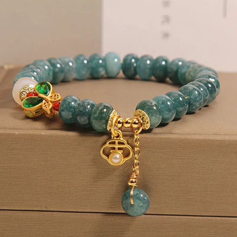 Blue jade abacus beads crystal bracelet with alloy inlay, rhinestone accents, butterfly charms and white agate beads