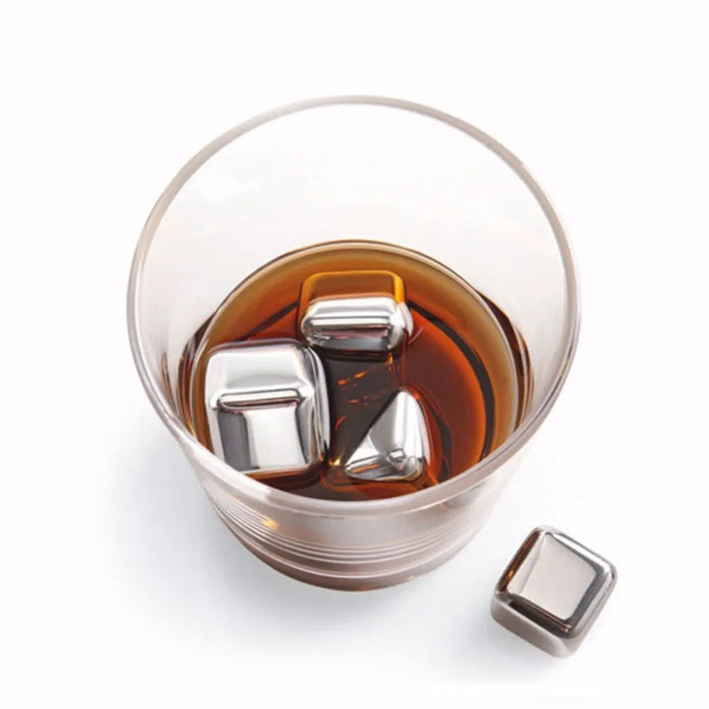 Set of eight stainless steel whiskey chilling stones and metal clip in storage box.