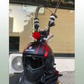 Zijin Crown gold motorcycle helmet feather ornament with long black plume attached to a black helmet.