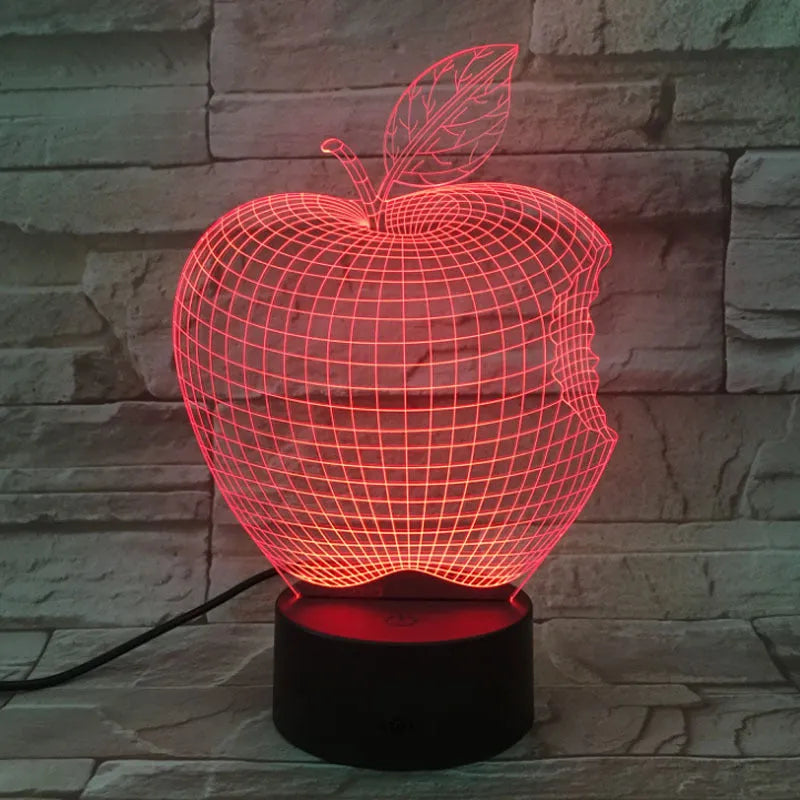 3D fruit-shaped colourful acrylic night light with touch control on a dark surface.