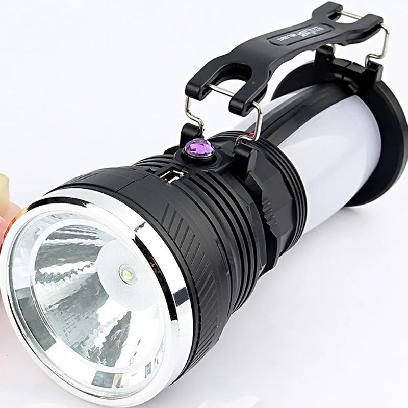 Black solar-charging LED emergency flashlight with USB port for outdoor use.