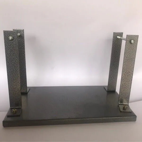Black iron flip chip bracket for portable electric planer on a workbench.