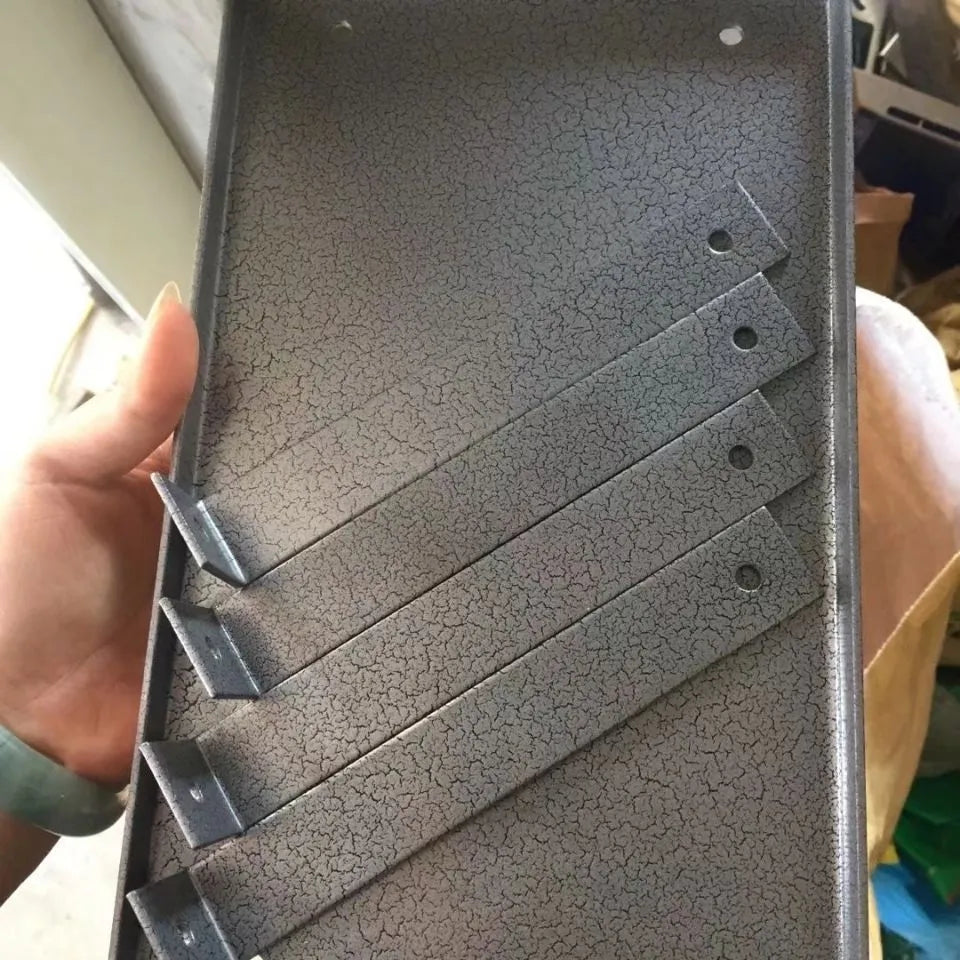 Black iron flip chip bracket for portable electric planer on a workbench.