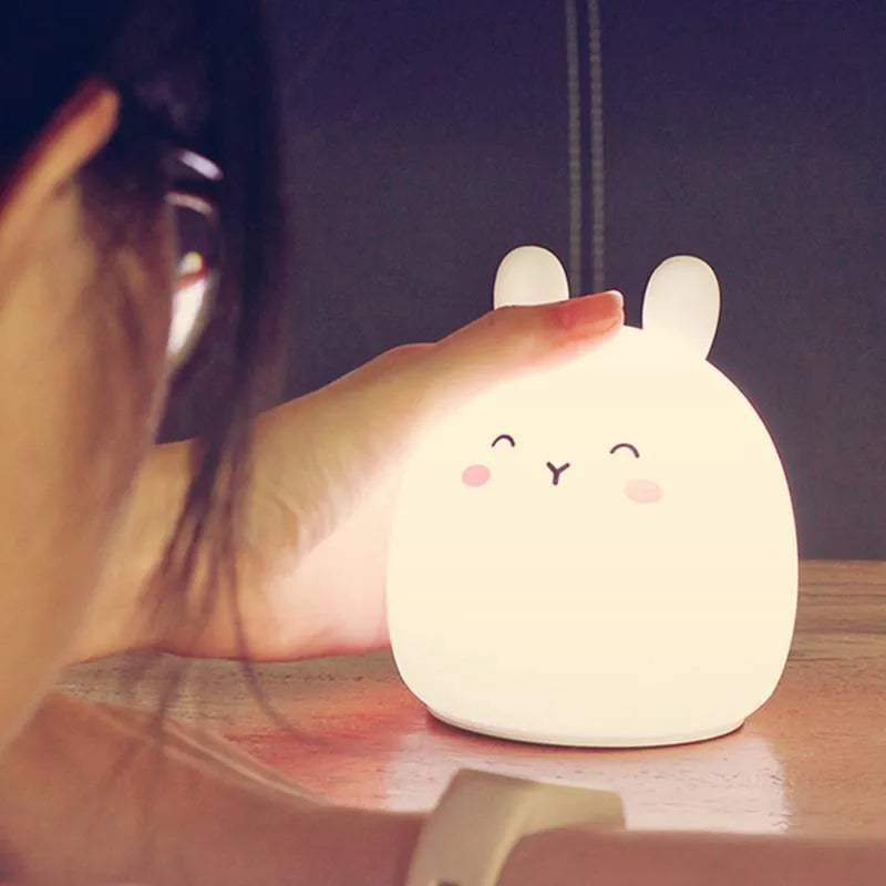 Silicone cute rabbit rechargeable night light with LED glow on bedside table