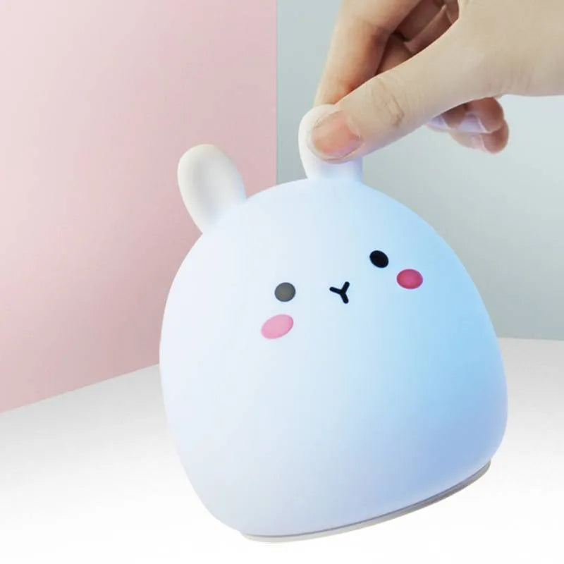 Silicone cute rabbit rechargeable night light with LED glow on bedside table