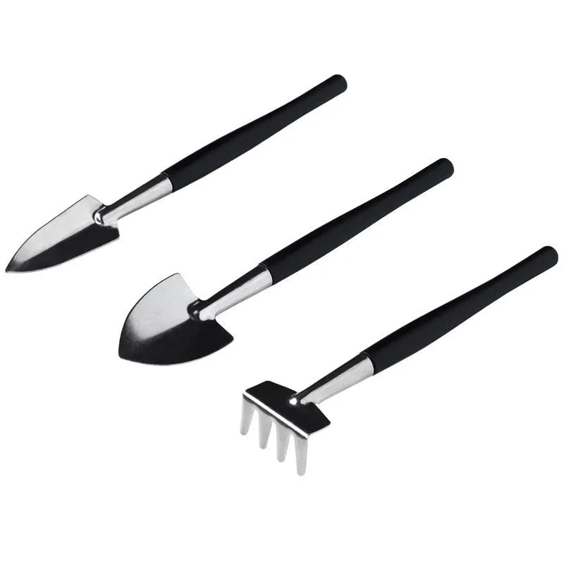 16-piece black mini garden tool set for succulents arranged on a 75cm square cushion mat, includes watering bottles, tweezers, and small shovel.