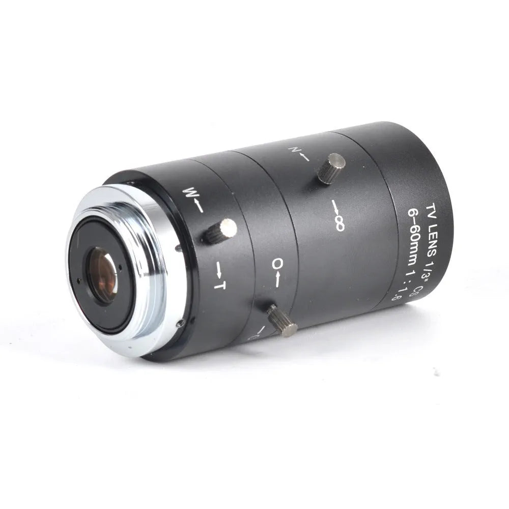 Black manual aperture 6-60mm CS mount CCTV camera lens on a flat surface.