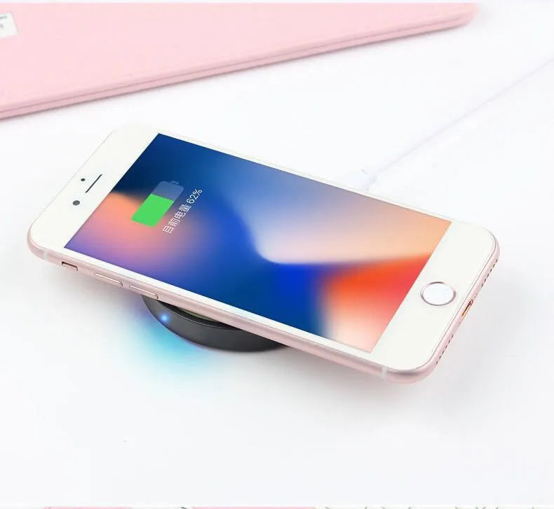 A compact square wireless charging base for mobile phones, shown in multiple colour options.