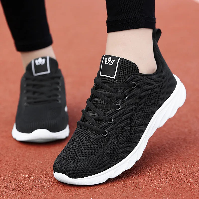 Women's flat casual shoe in white with high-top design and back lacing.