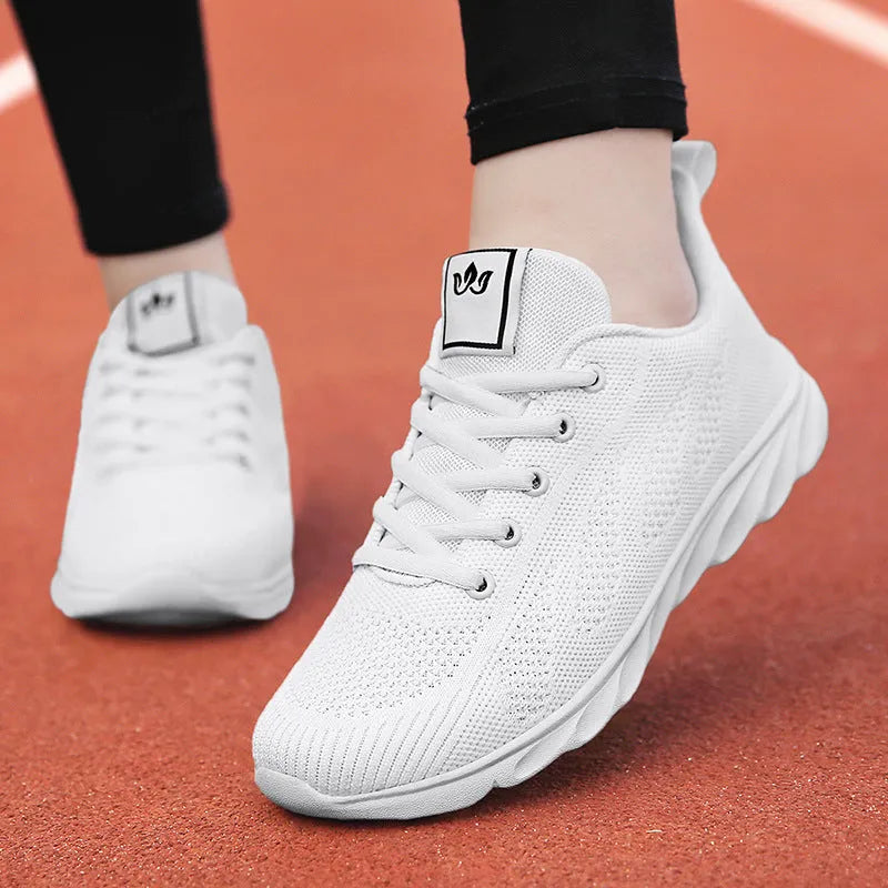 Women's flat casual shoe in white with high-top design and back lacing.