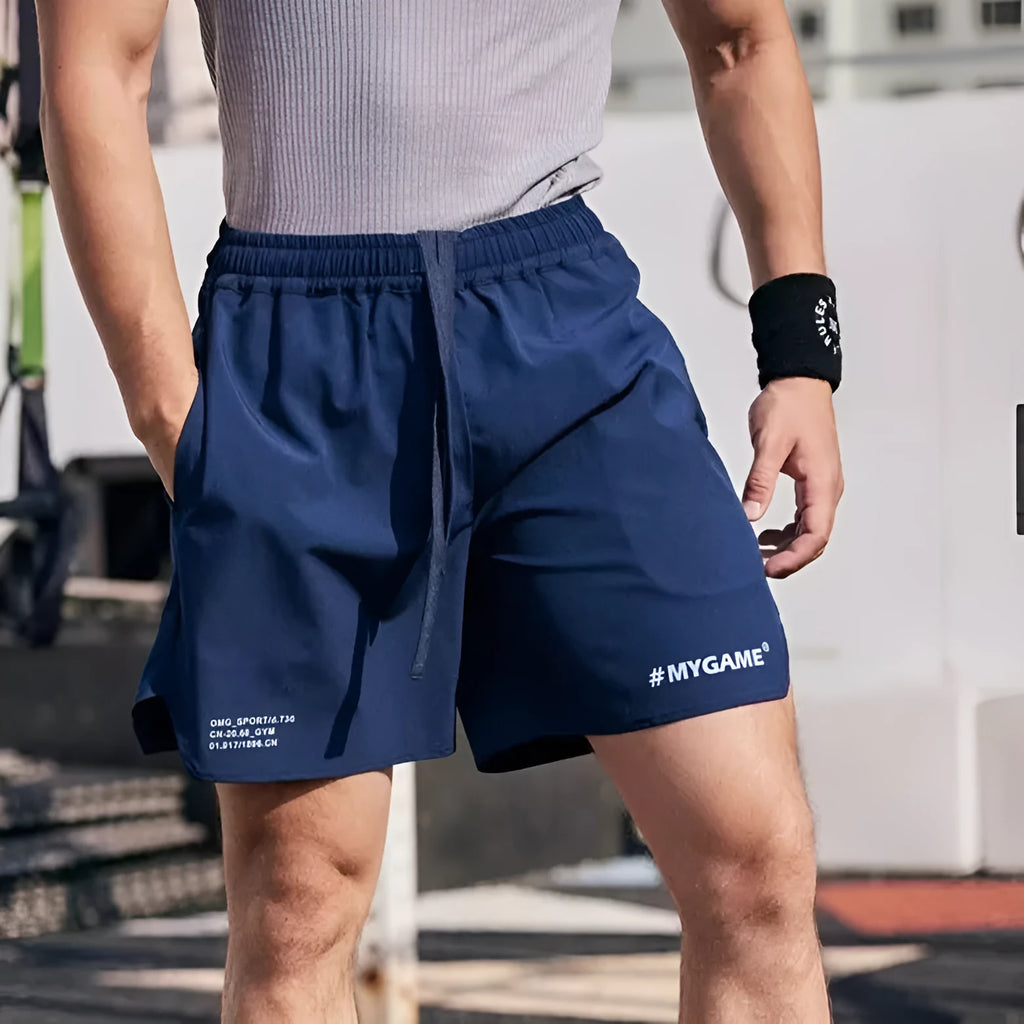 Men's grey quick-dry fitness shorts with high elasticity for gym training on a plain background.