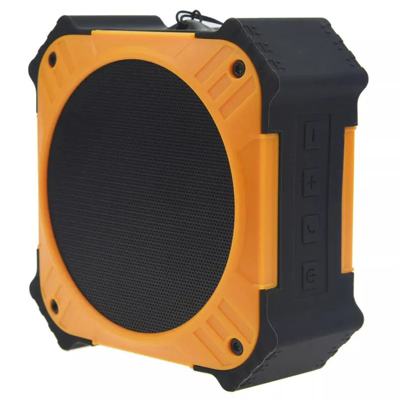 Compact black waterproof Bluetooth speaker with a wrist strap, shown next to a charging cable.