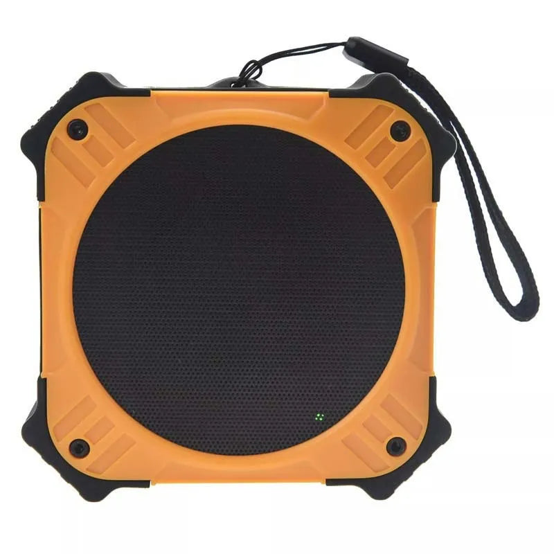Compact black waterproof Bluetooth speaker with a wrist strap, shown next to a charging cable.