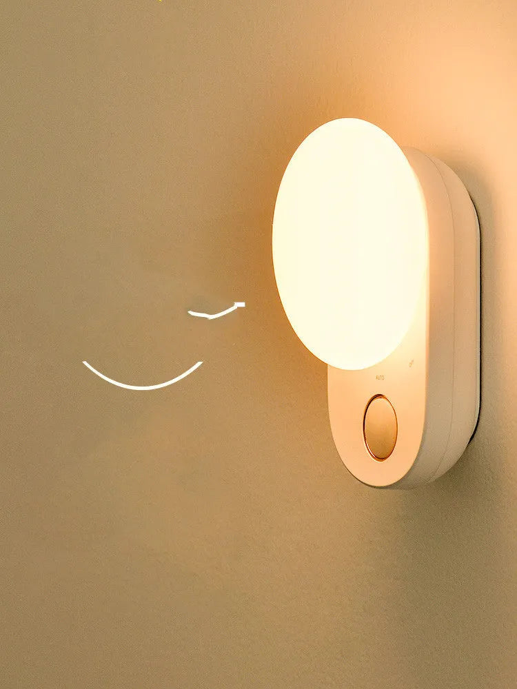 White Baseus rechargeable night light with motion sensor and sleeping light mode on a surface.