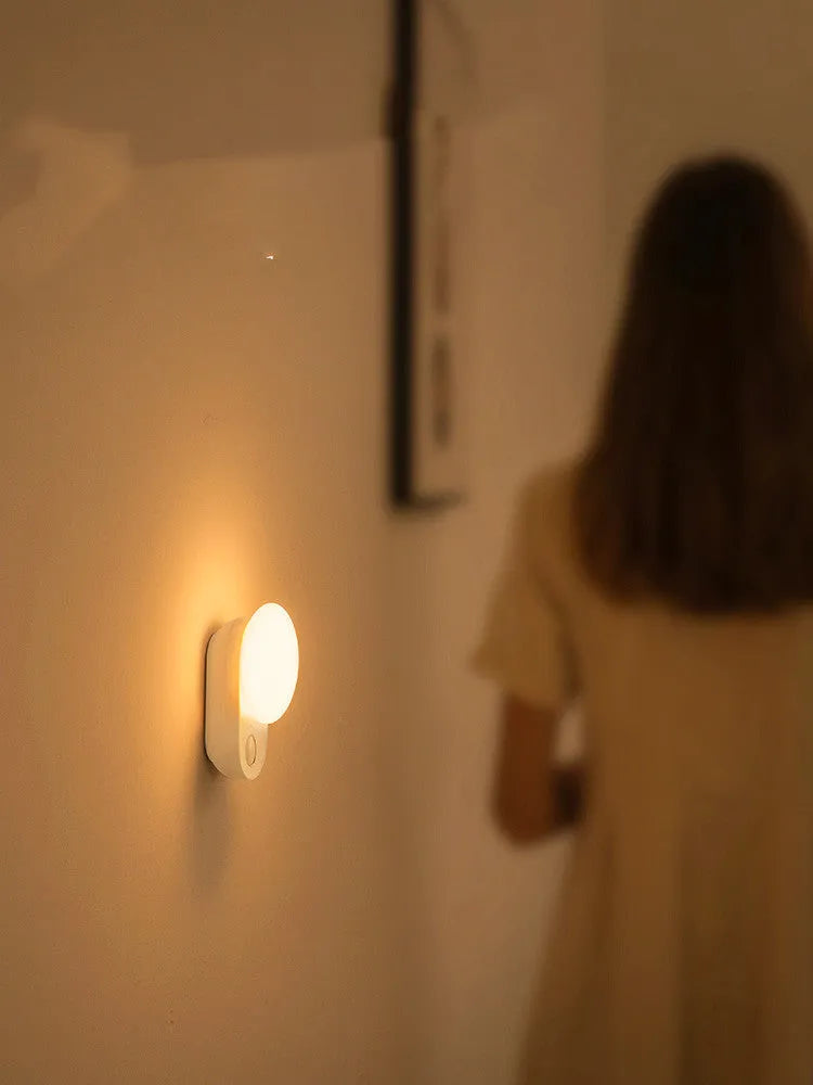 White Baseus rechargeable bedside night light with motion sensor and sleep mode.
