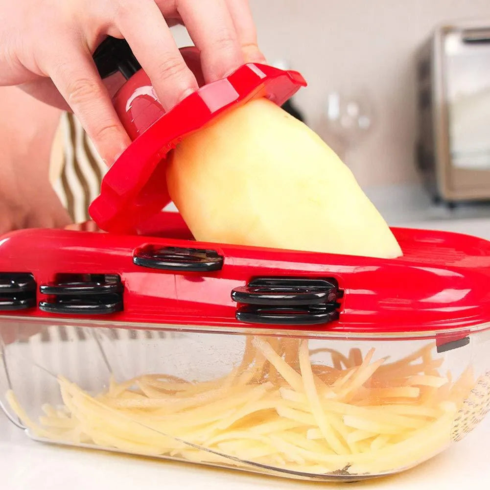 Red multi-function vegetable cutter with seven stainless steel blades and a clear PET collection container.