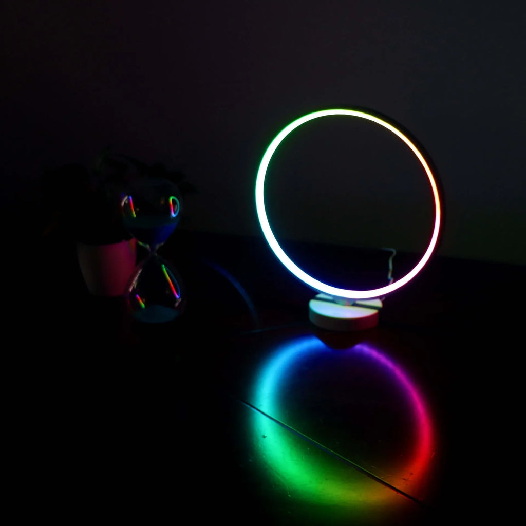 White Full Moon Lamp table light with remote control on a wooden surface.