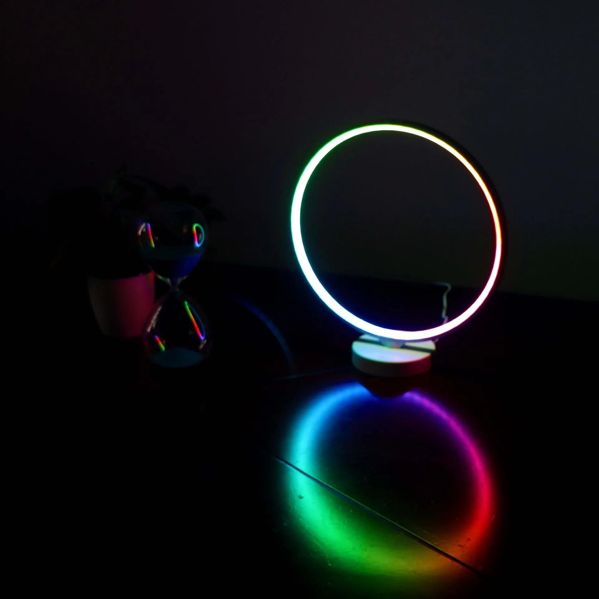 White Full Moon Lamp table light with remote control on a wooden surface.