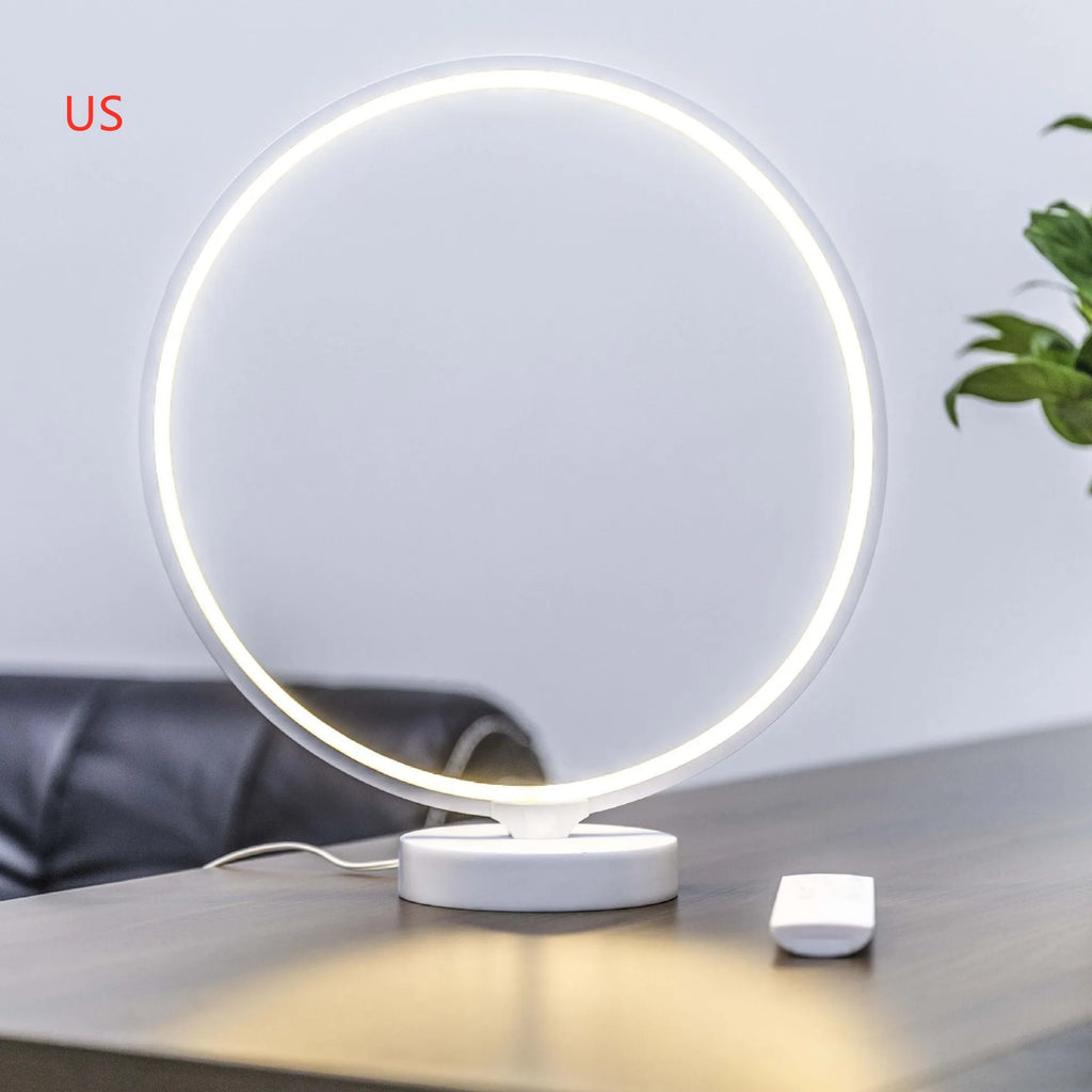 White Full Moon Lamp table light with remote control on a wooden surface.