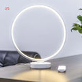 White Full Moon Lamp table light with remote control on a wooden surface.