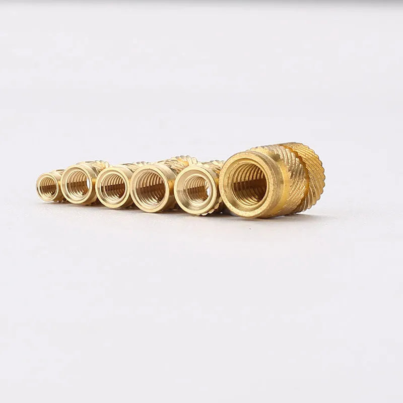 Brass hot melt copper nuts with M2 and M3 threads in various heights on a white background.