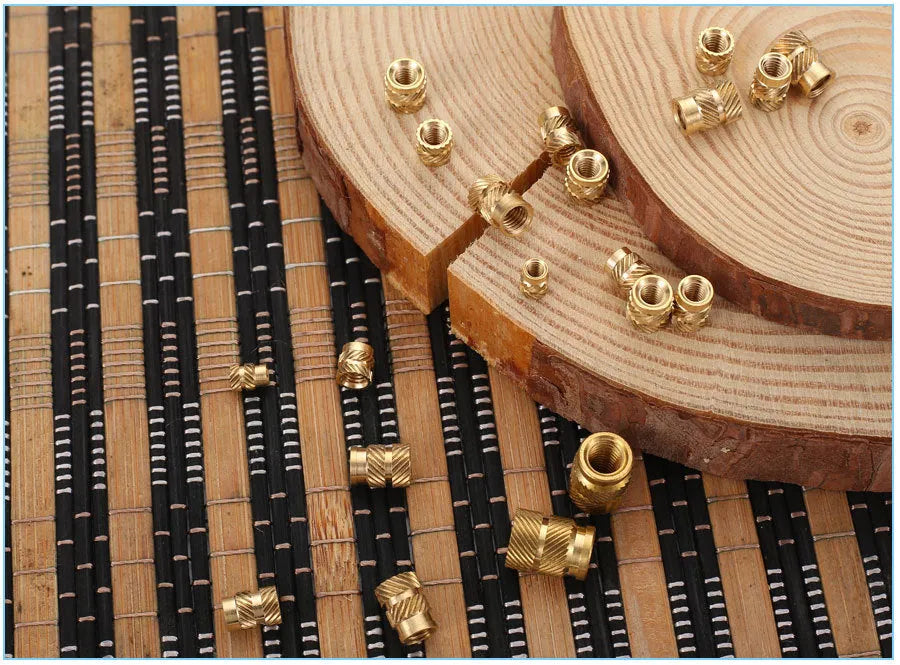 Brass hot melt copper nuts with M2 and M3 threads in various heights on a white background.