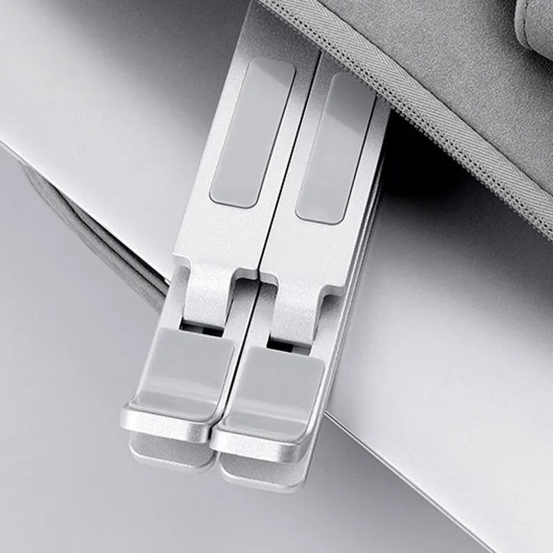Double-layer aluminium alloy laptop stand in silver, folded with flannel bag, 80 kg load capacity