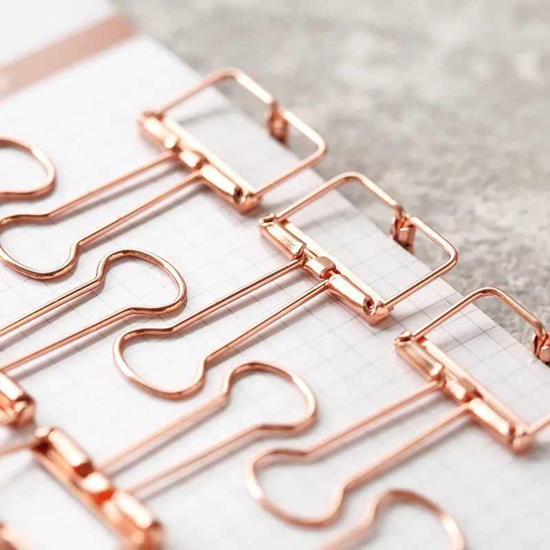 Rose gold metal binder clip set showing eight small and six large clips for document organisation