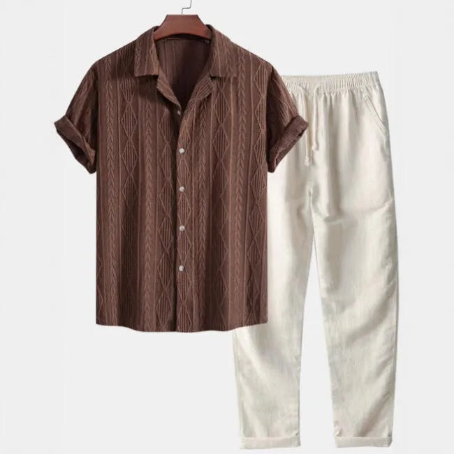 Lightweight linen-feel casual suit set with camouflage print trousers and a short-sleeved lapel shirt.