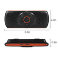 Orange Bluetooth car hands-free phone kit mounted on vehicle sun visor for wireless calling