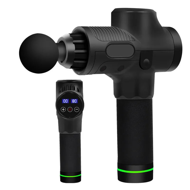 Black electric muscle massage gun with multiple attachment heads on a table.