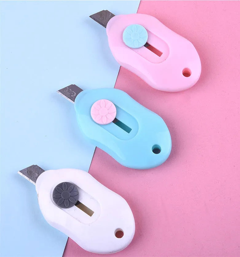 Cartoon character art knife with open box design showing plastic body and metal blade