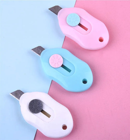 Cartoon character art knife with open box design showing plastic body and metal blade