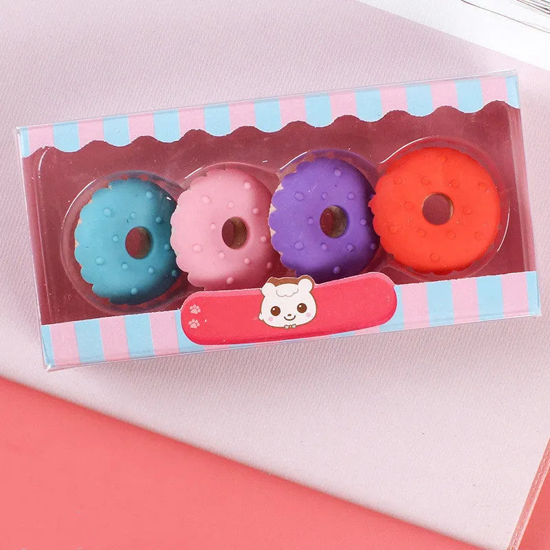 Set of 12 colourful cartoon erasers shaped like ice cream cones, lollipops, and donuts for children.