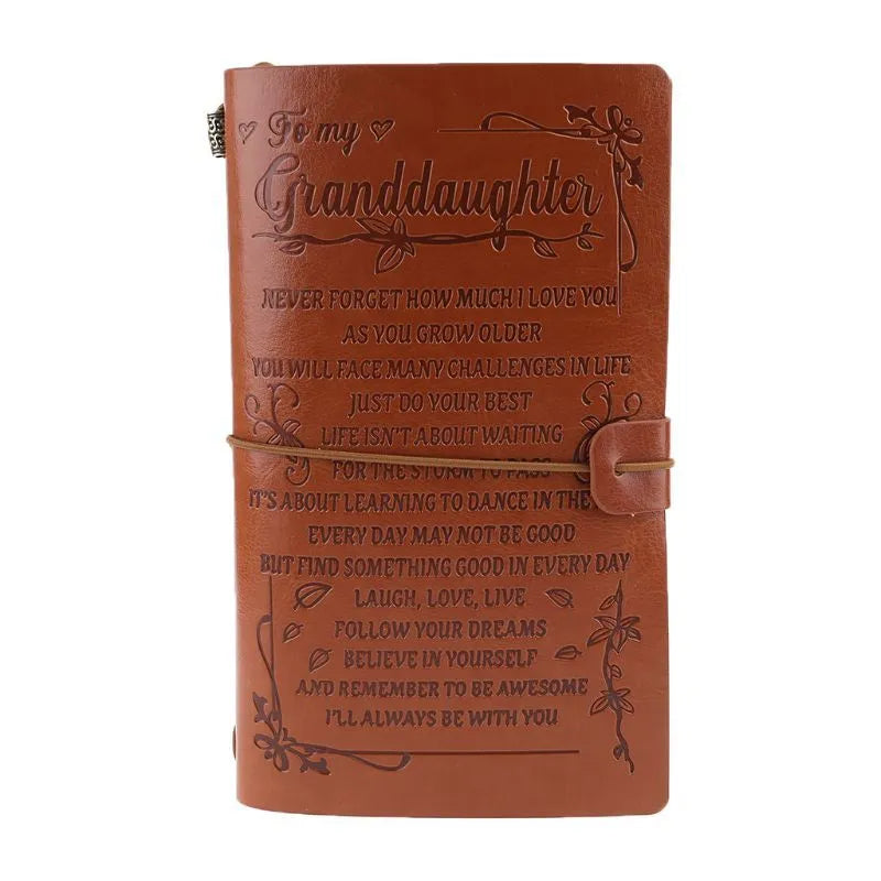 Brown leather hand ledger notebook with strap binding showing warm brown acid-free paper inside