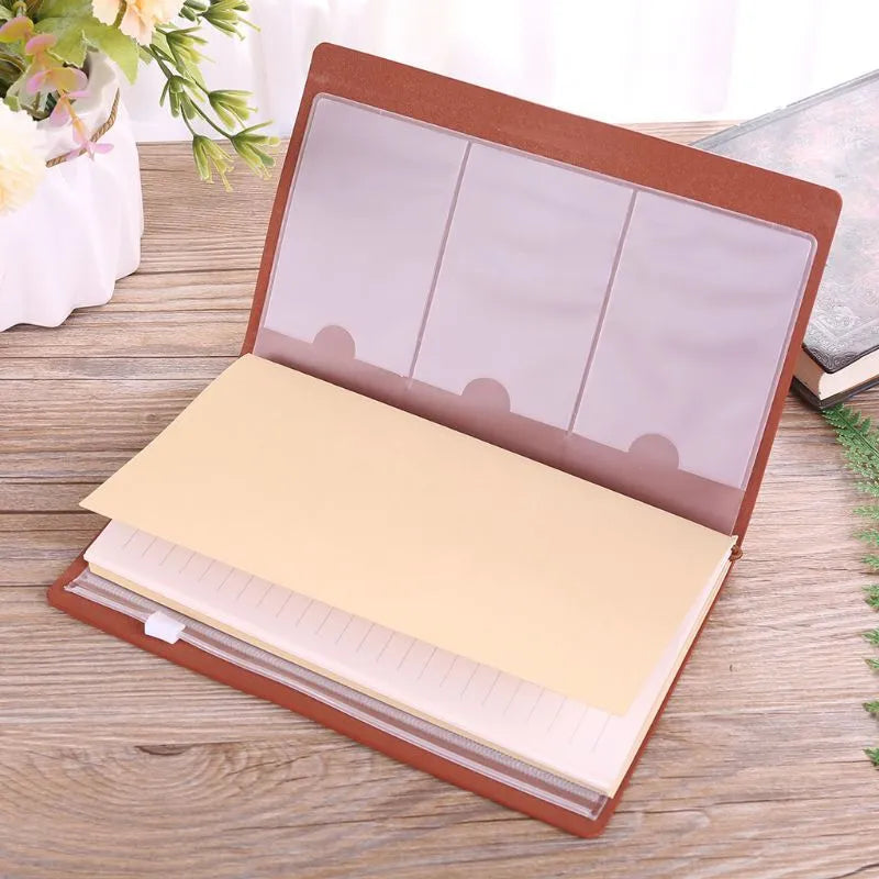 Brown leather hand ledger notebook with strap binding showing warm brown acid-free paper inside