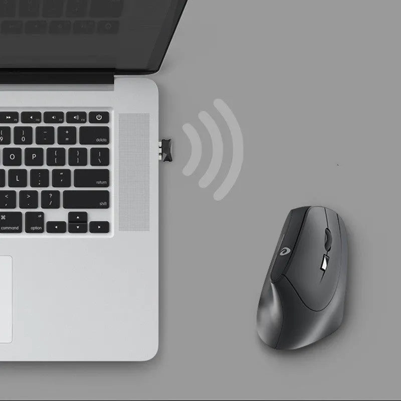 Black 2.4G wireless ergonomic gaming mouse with six buttons and USB receiver on desk