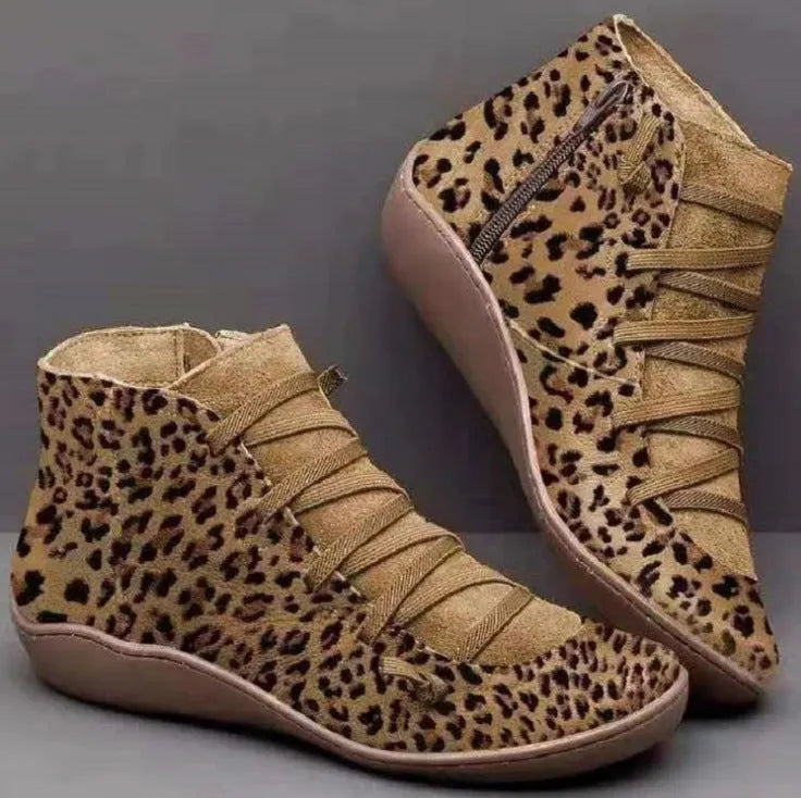 Women's casual flat booties with a wedge heel and round toe in assorted colours.