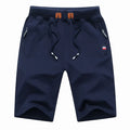 Men's cotton drawstring summer shorts in green with elastic waist and pockets, side view