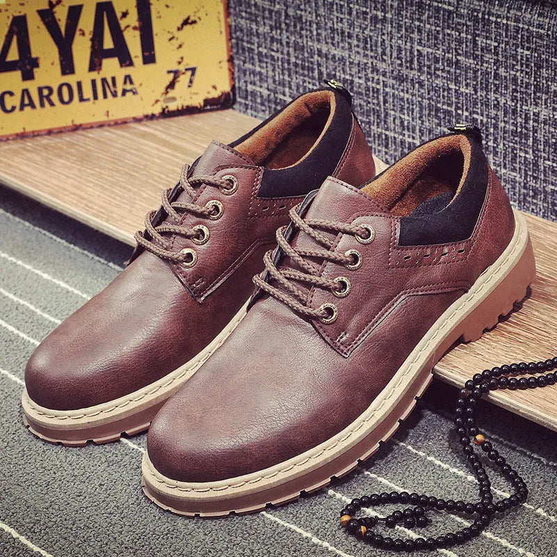 Men's black casual lace-up shoes with a round toe and flat rubber sole on a plain background.