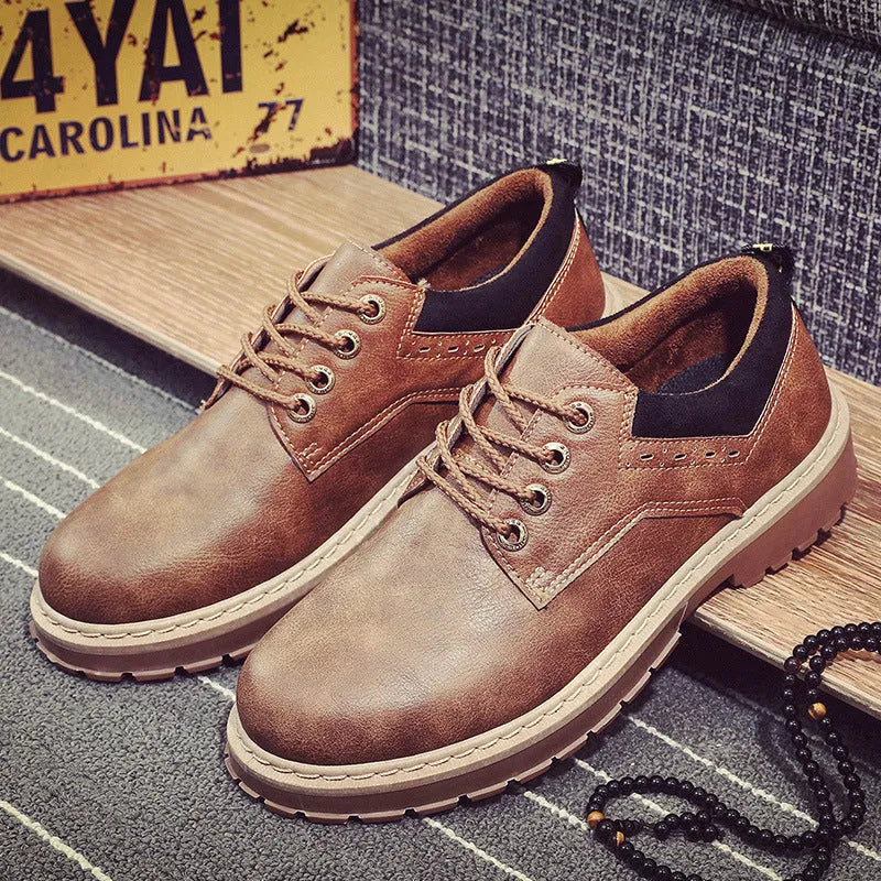 Men's black casual lace-up shoes with a round toe and flat rubber sole on a plain background.