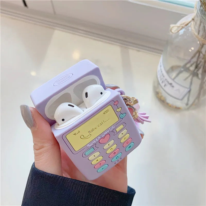 Purple silicone AirPods protective case with fur ball pendant attached to clamshell design