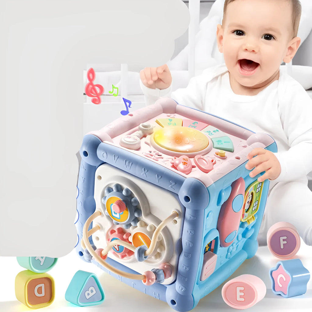 Blue baby musical hand drum toy with piano keys, geometric blocks, and easy-grip handle on white background