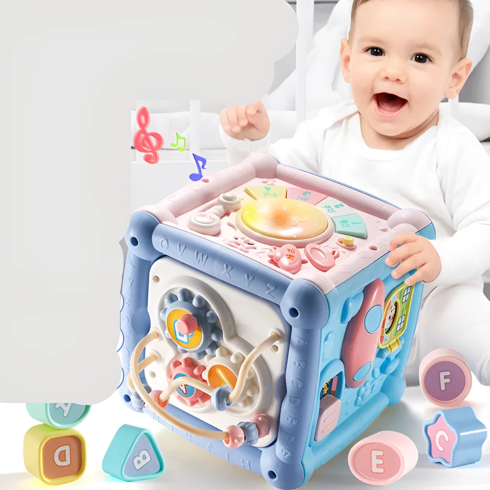 Blue baby musical hand drum toy with piano keys, geometric blocks, and easy-grip handle on white background