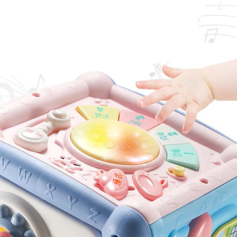 Blue baby musical hand drum toy with piano keys, geometric blocks, and easy-grip handle on white background