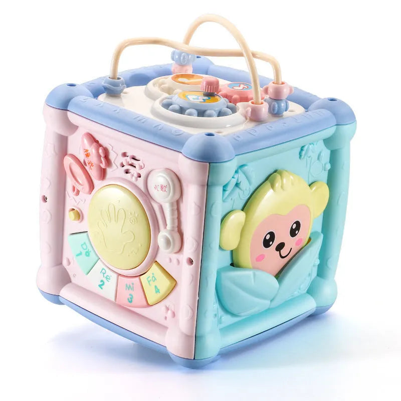 Blue baby musical hand drum toy with piano keys, geometric blocks, and easy-grip handle on white background
